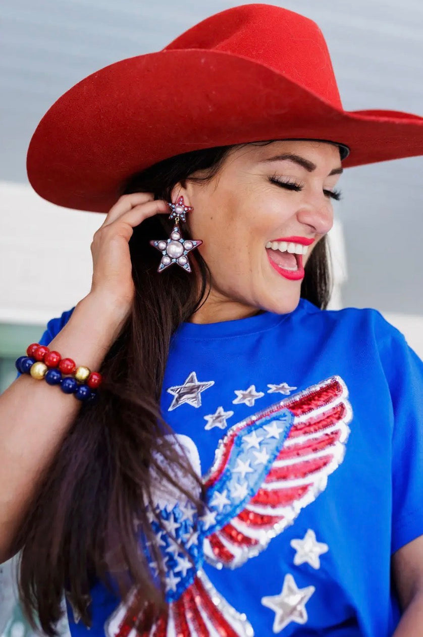 Big Star earrings by Brianna Cannon featuring silver-tone star-shaped dangle jewelry on a white background.