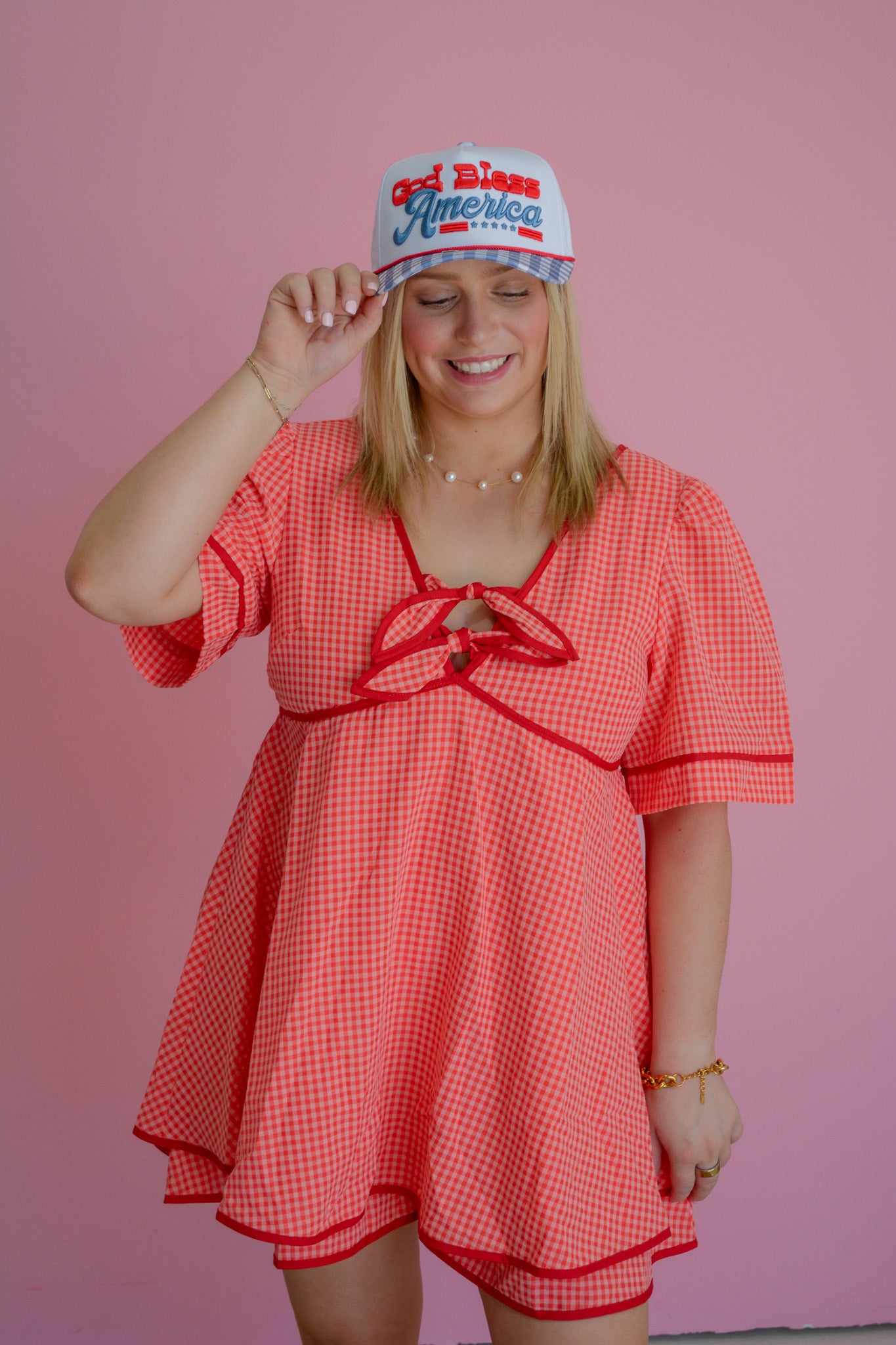 Cherry Picnic Dress by Peach Love California, featuring a floral print and flowy silhouette, displayed on a hanger.
