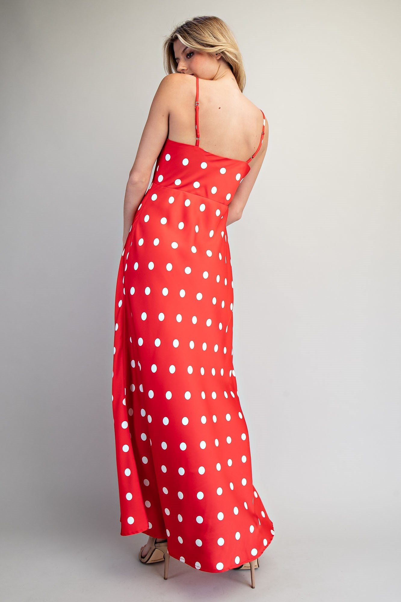 Eesome Dottie Delight Dress displayed on a hanger, featuring a playful polka dot pattern and a stylish, feminine silhouette.
