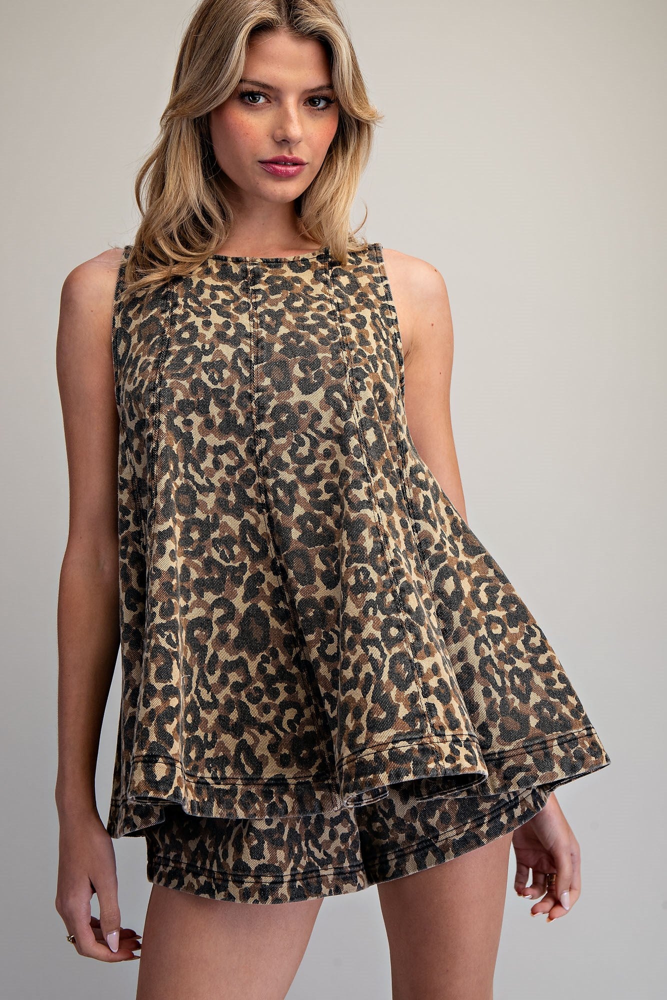Ee:some Fierce & Free Top displayed on a hanger with colorful background, showcasing its stylish design and vibrant fabric.