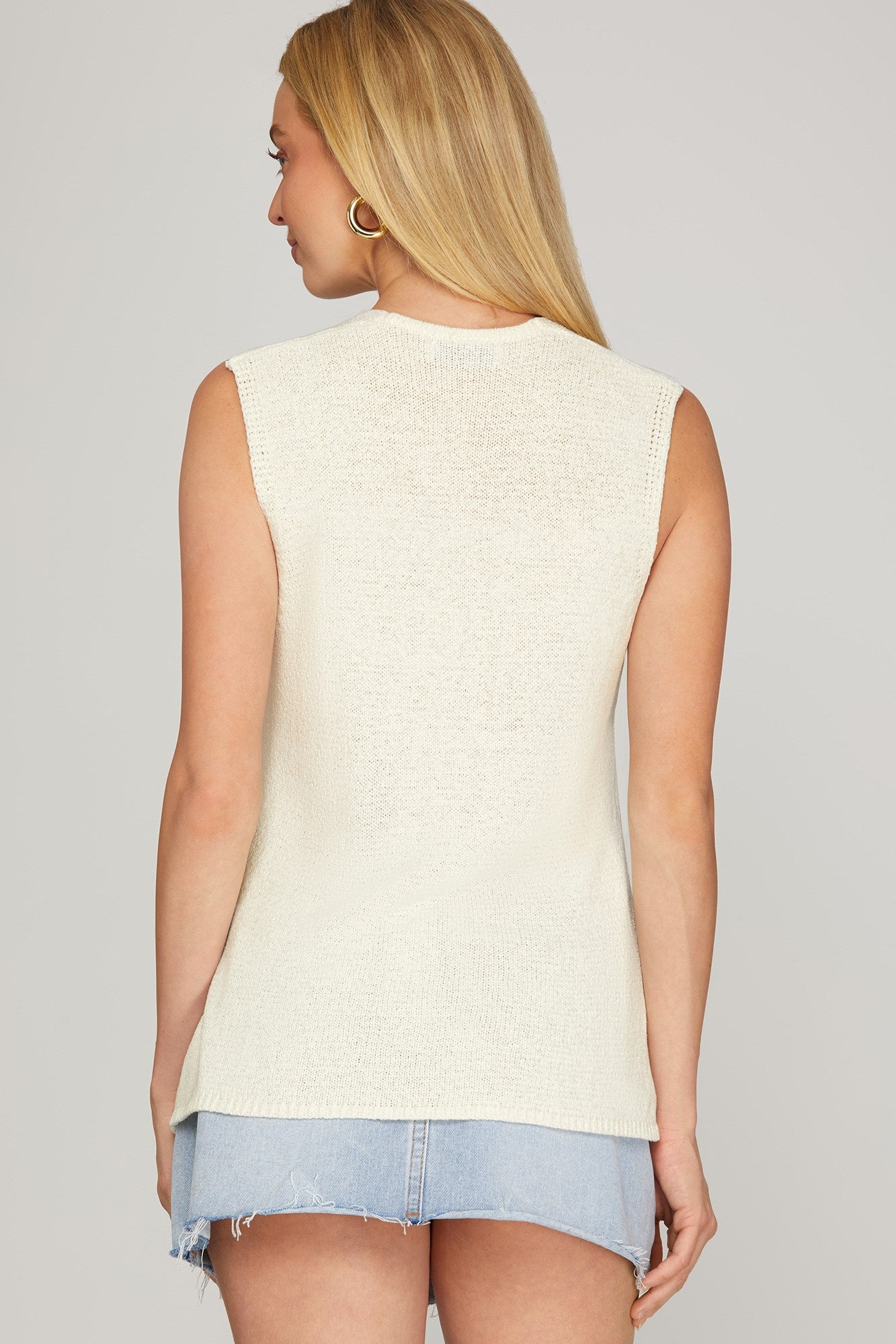 Off-White The It Girl Sweater Vest by She+Sky, featuring a stylish knit design with a high neckline and vibrant color accents.