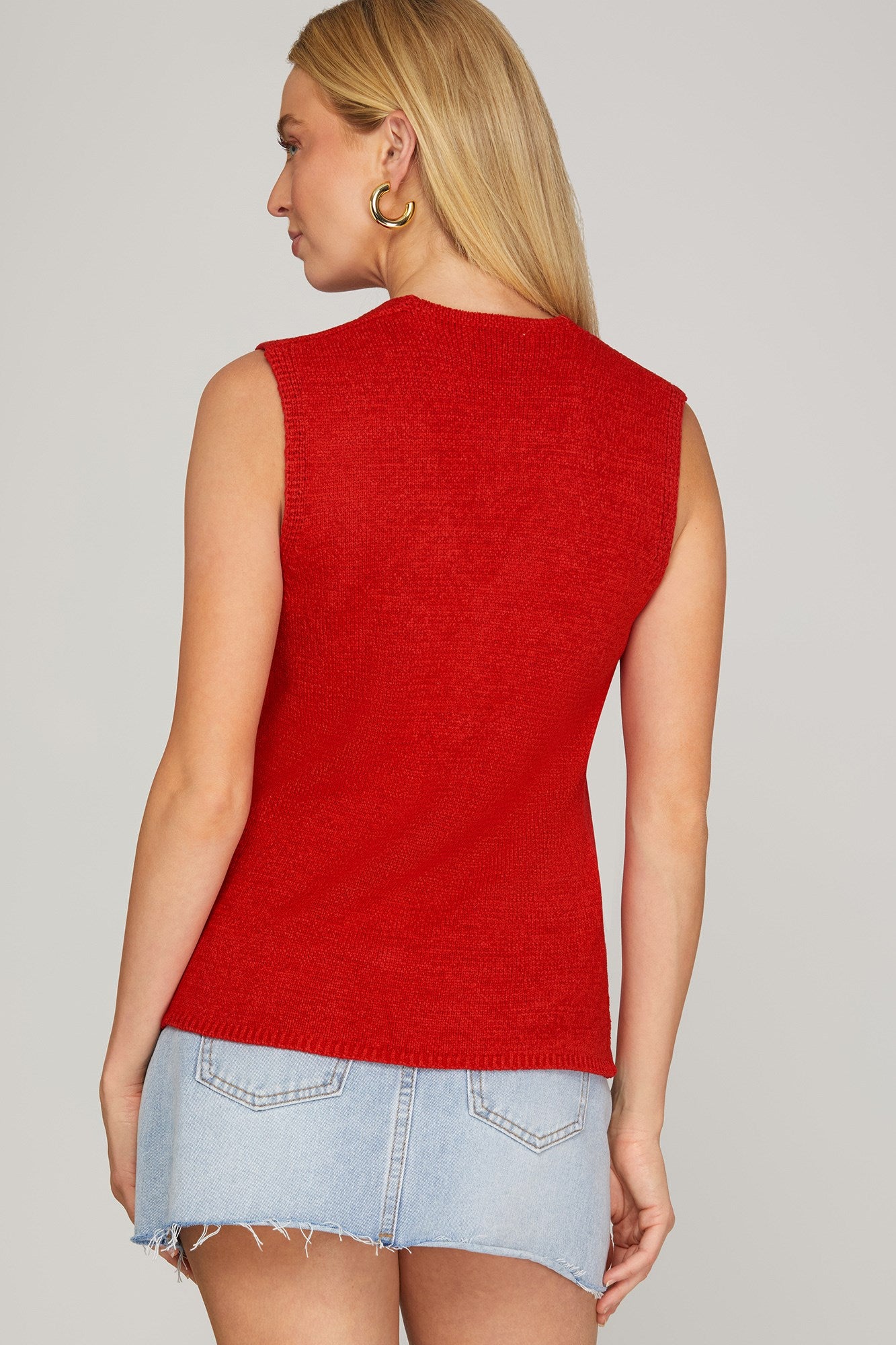 Red She+Sky It Girl Sweater Vest displayed on a hanger with a ribbed neckline and armholes, showcasing casual knitwear style.