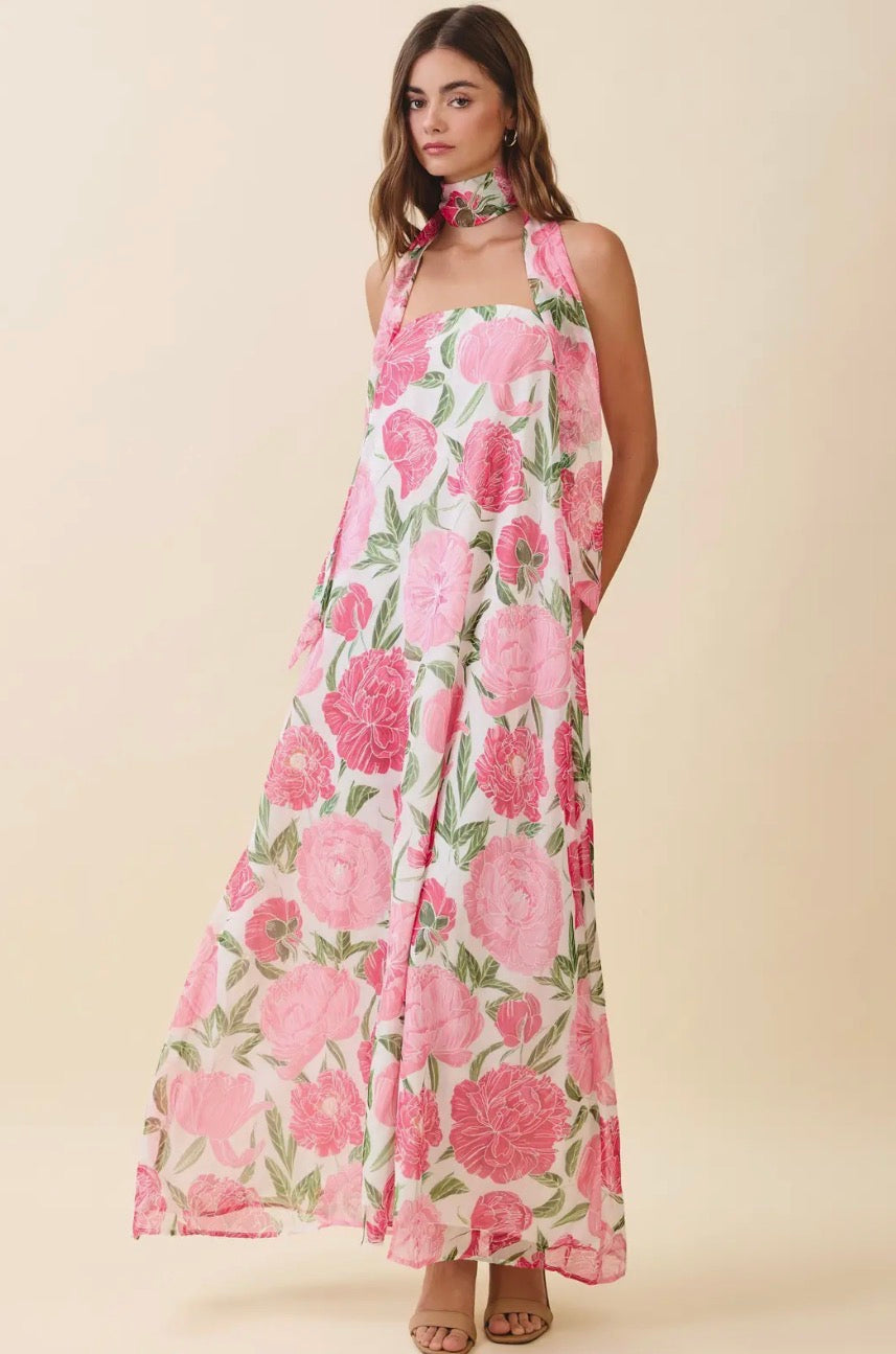 TCEC Blossom Breeze Maxi Dress with floral print, flowing fabric, and sleeveless design worn by a model outdoors.