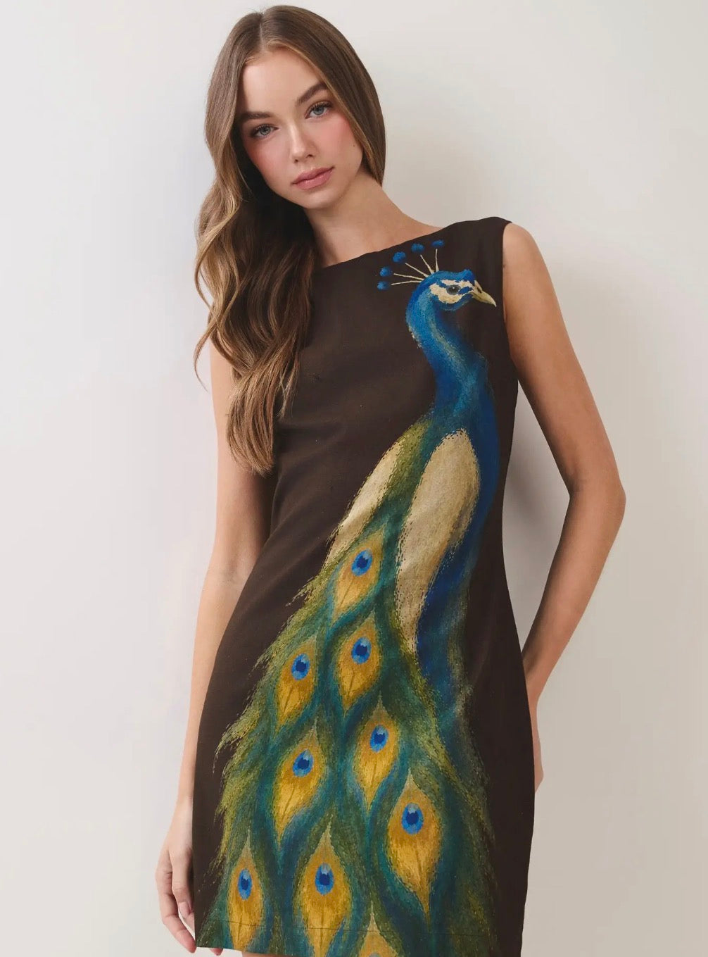 TCEC Chocolate Peacock mini dress featuring a fitted silhouette, vibrant peacock feather print, and stylish sleeveless design.