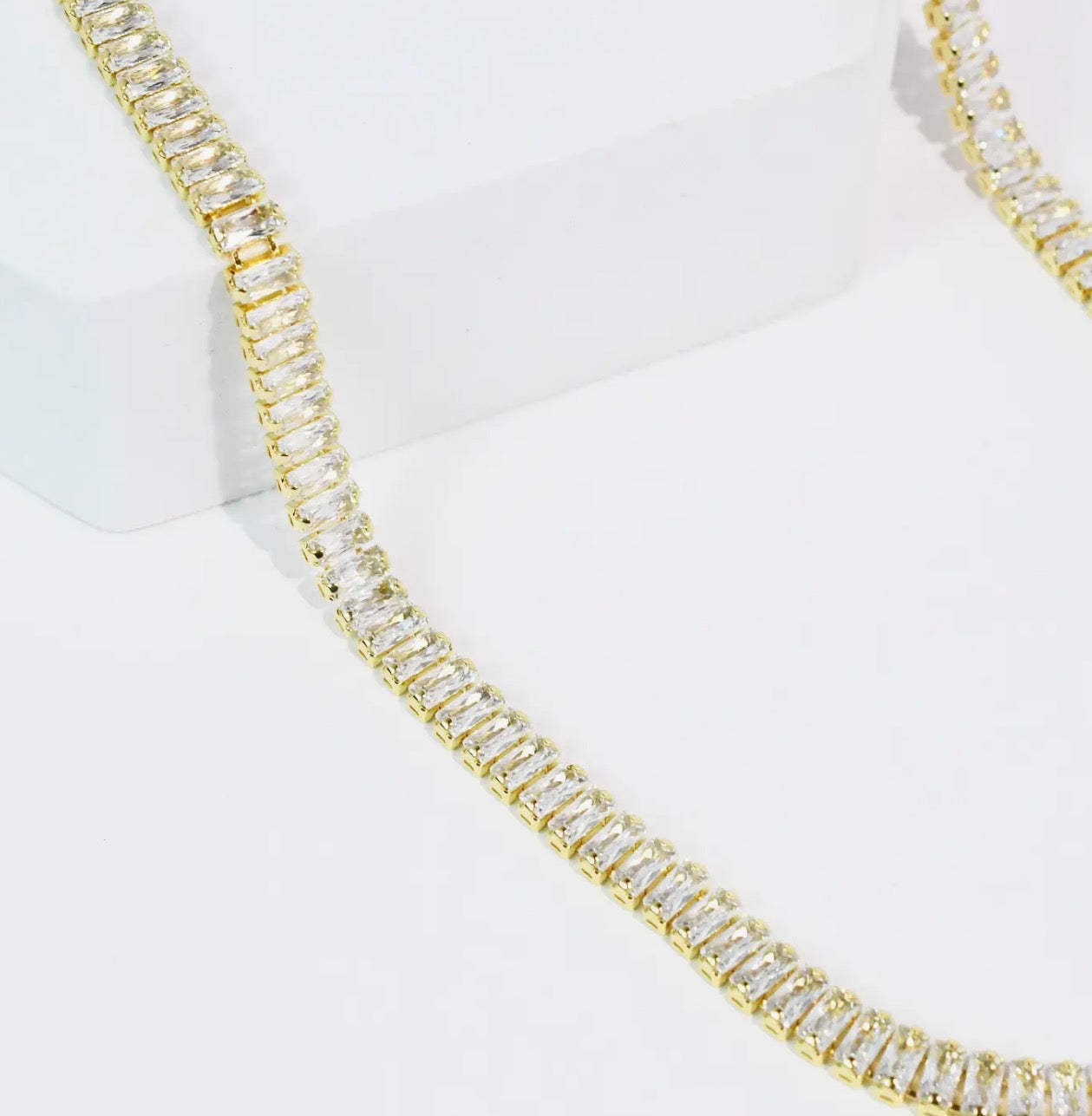 Treasure Jewels Royale Necklace featuring intricate gold chain and sparkling gemstone accents.