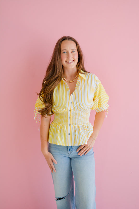Entro Sunshine Girl Top displayed on a mannequin, featuring a vibrant, stylish women's blouse with floral patterns and lightweight fabric.