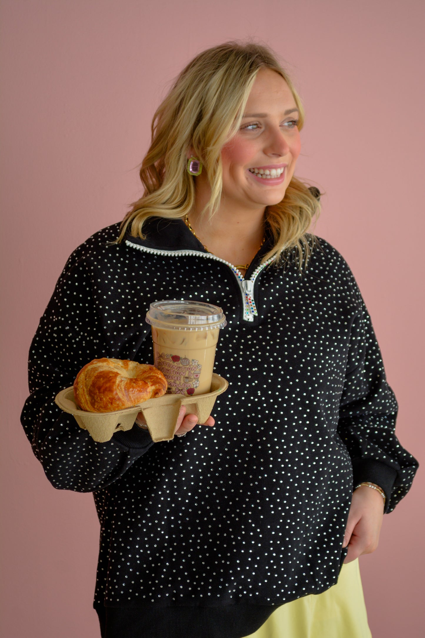 Bell St Boutique Sparkle & Sport quarter zip top in black with silver sparkle details, shown on a hanger.