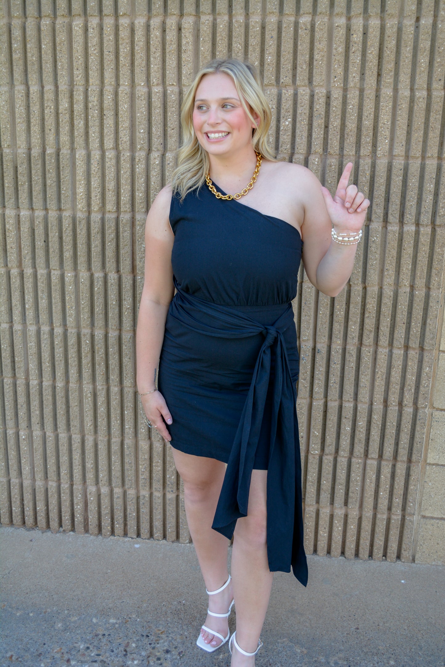 TCEC Bows and Confetti Wrap Dress shown on a model, featuring colorful bow and confetti patterns, V-neckline, and long sleeves.