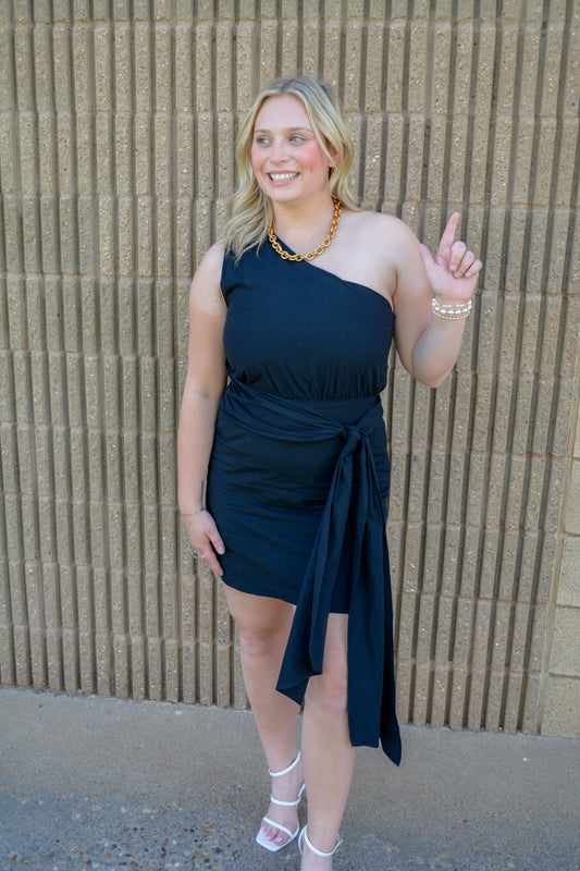 TCEC Bows and Confetti Wrap Dress shown on a model, featuring colorful bow and confetti patterns, V-neckline, and long sleeves.