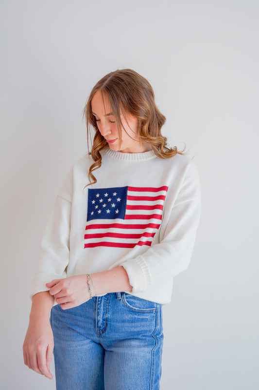 TCEC Stars & Stripes sweater featuring patriotic star and stripe pattern in red, white, and blue on soft knit fabric.