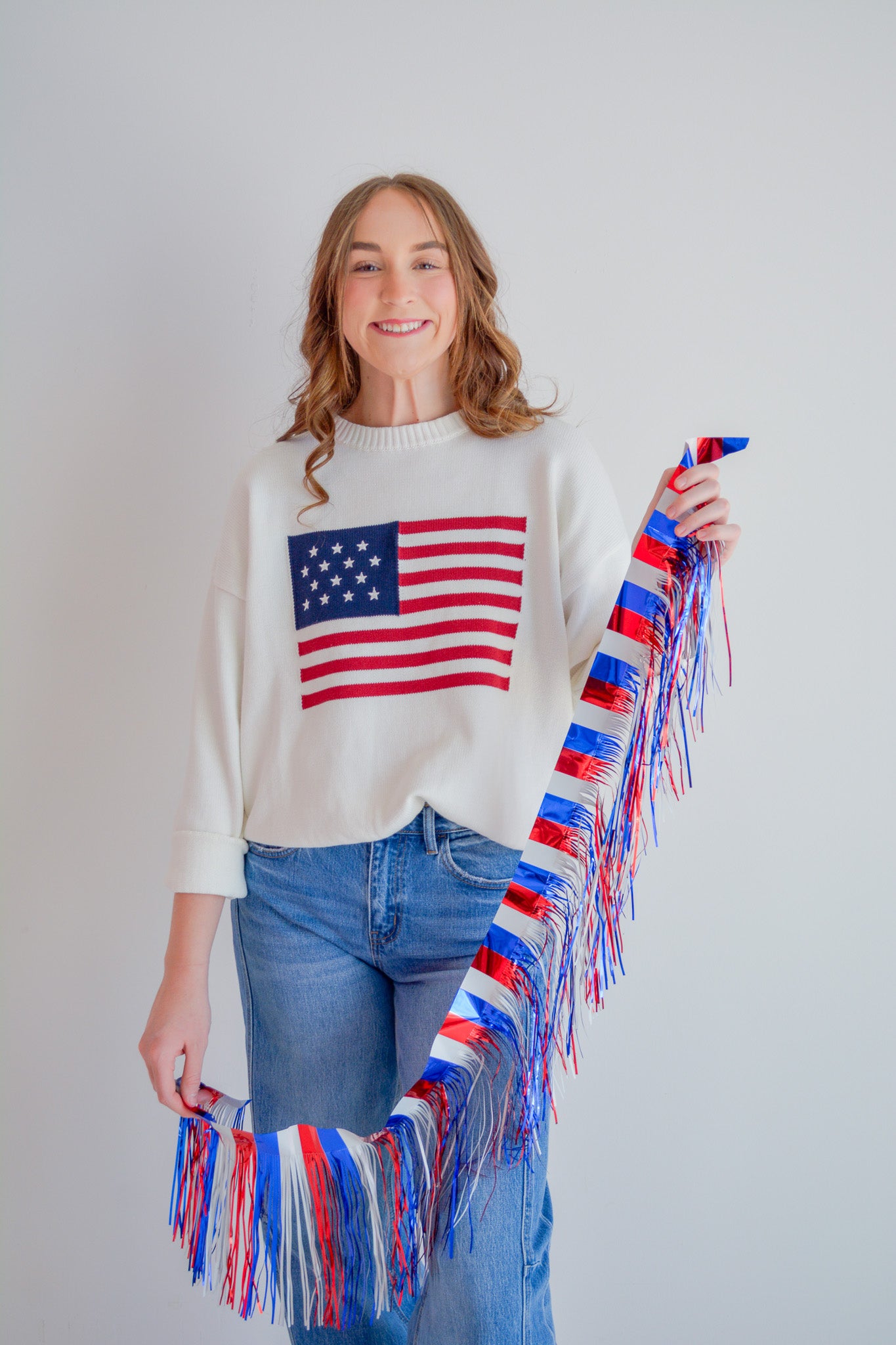 TCEC Stars & Stripes sweater featuring a patriotic design with red, white, and blue stars and stripes pattern.