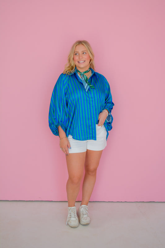 GLAM Shoreline Breeze Blouse featuring lightweight fabric, soft blue color, and casual style, displayed on a hanger.