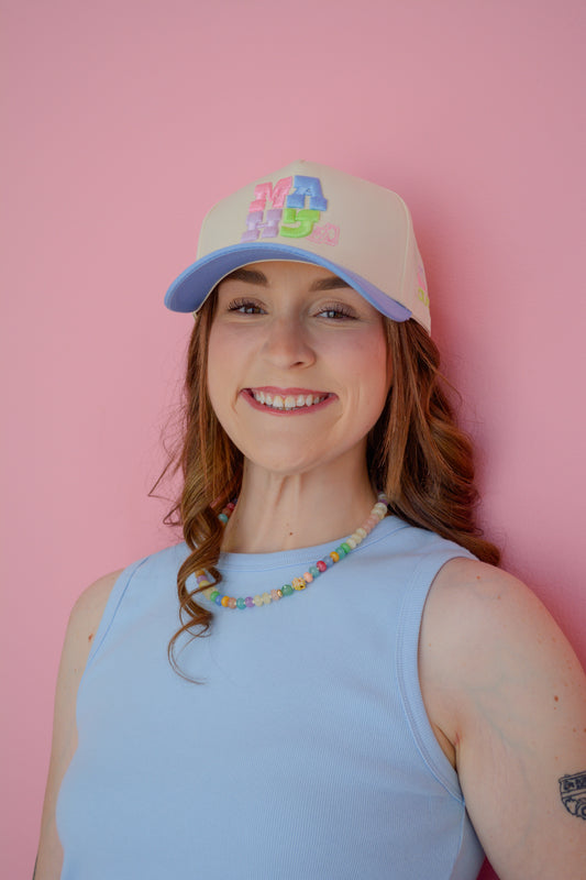 Blue MAJH hat by Summer Tees, shown in a natural outdoor setting, highlighting its casual style and adjustable brim.