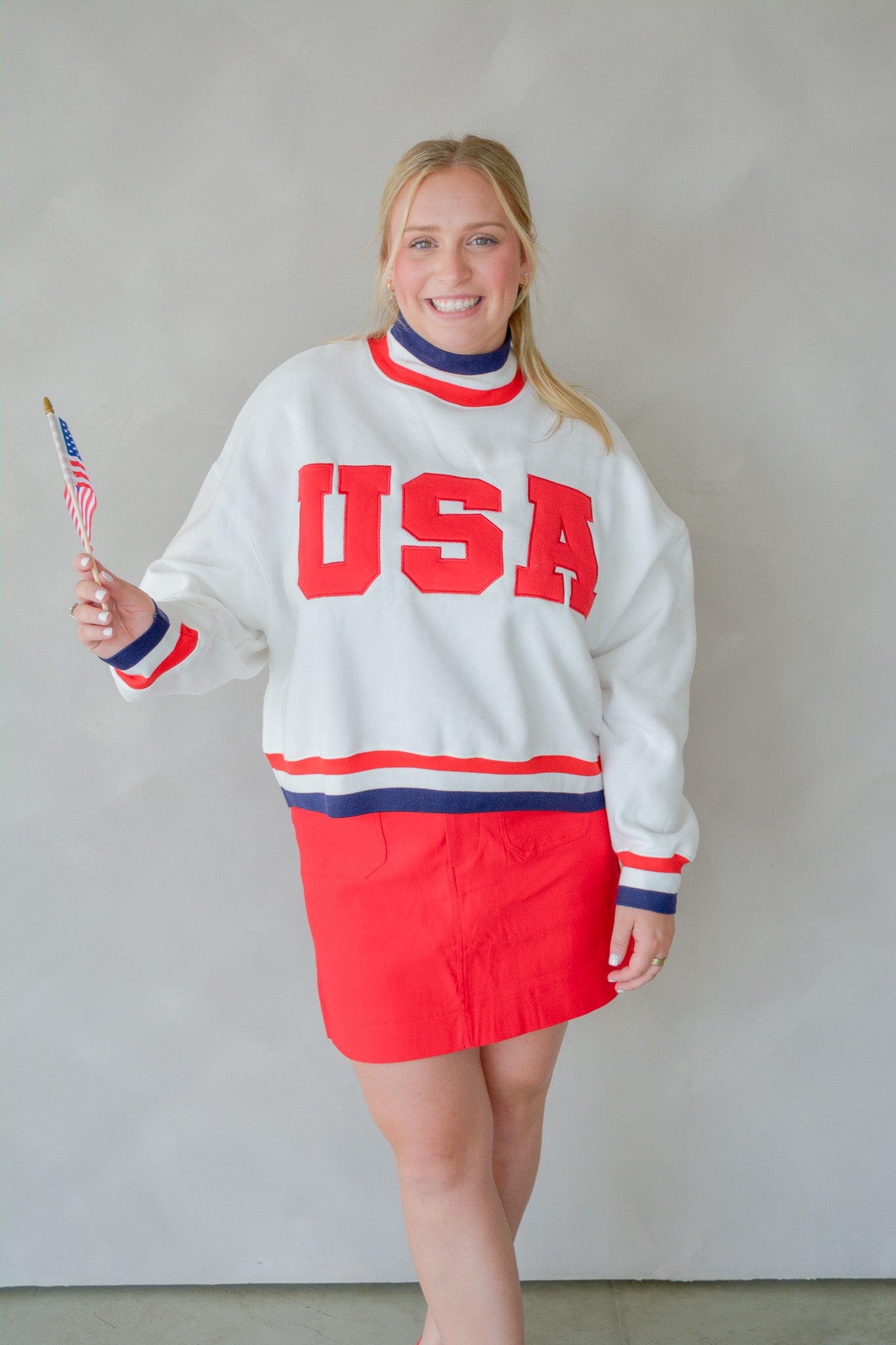 Front view of The All-American Pullover by TCEC, showcasing a classic navy blue sweatshirt with a crew neck and subtle branding.