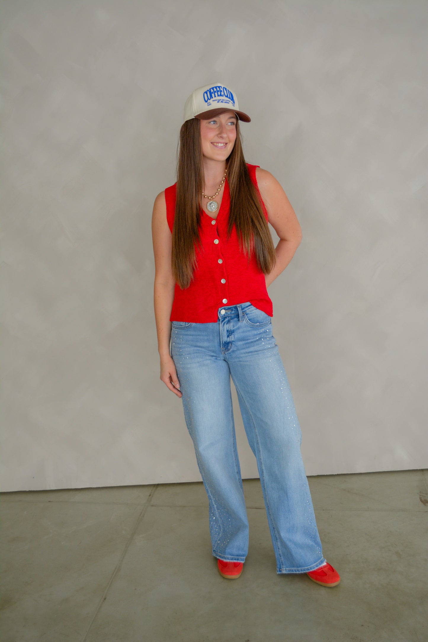 Vervet Glam wide-legged jeans displayed on a hanger, featuring a high-rise fit and classic denim wash with a relaxed, fashionable style.