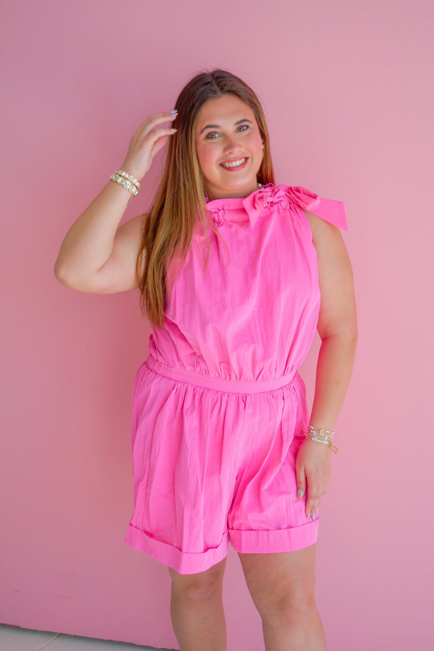 Pink Sugar Rush romper by GLAM, featuring a stylish and vibrant design, displayed on a hanger against a neutral background.