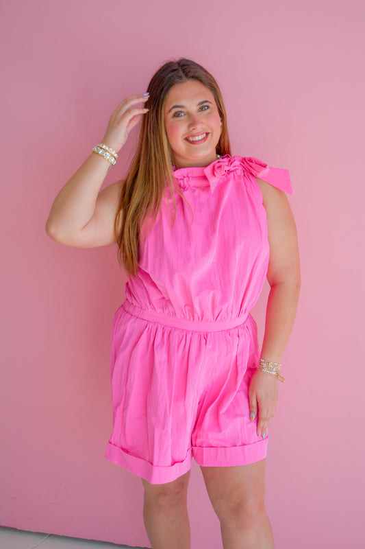 Pink Sugar Rush romper by GLAM, featuring a stylish and vibrant design, displayed on a hanger against a neutral background.