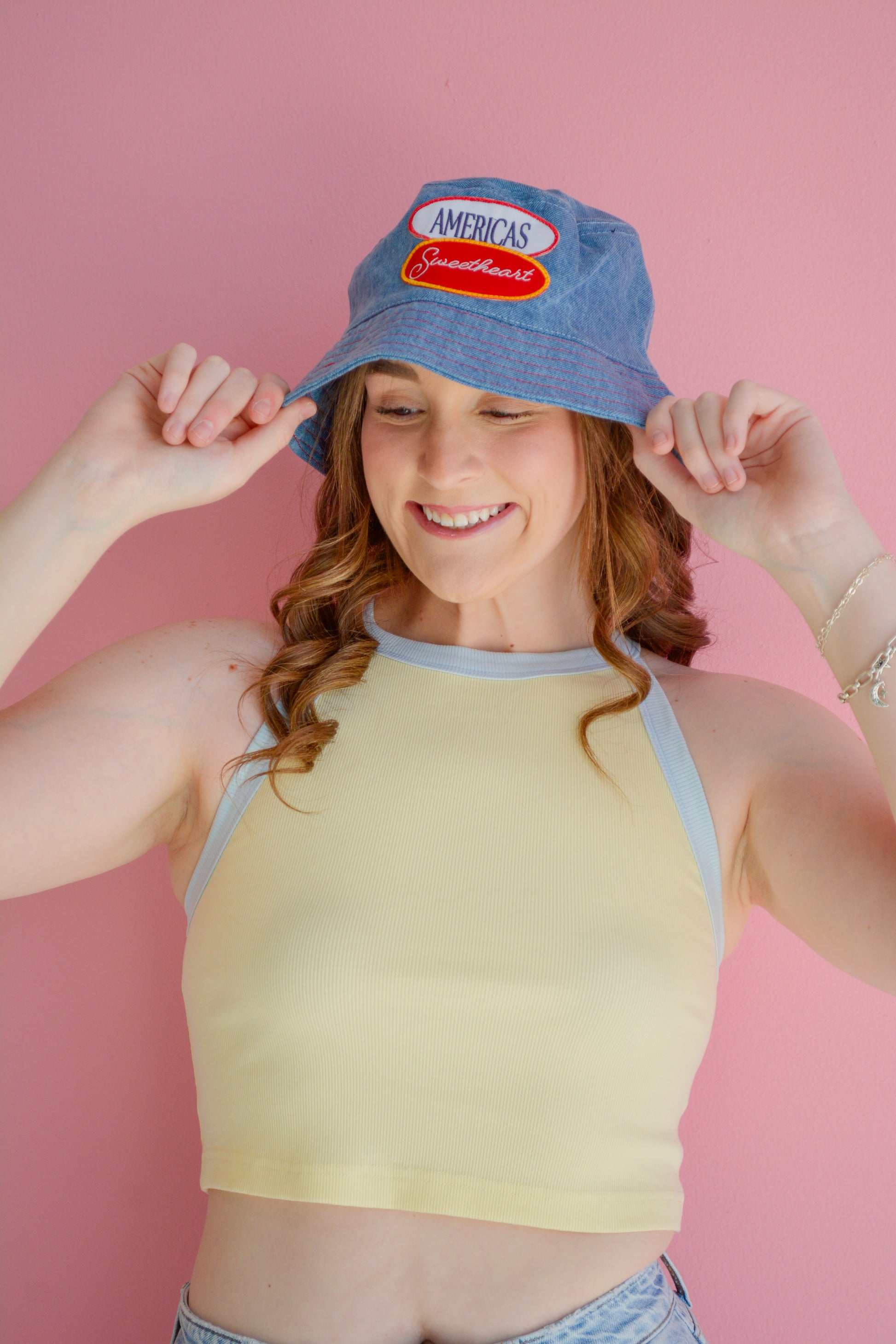Kaxi America's Sweetheart bucket hat in pink with a wide brim, stylish sun protection accessory for casual wear.