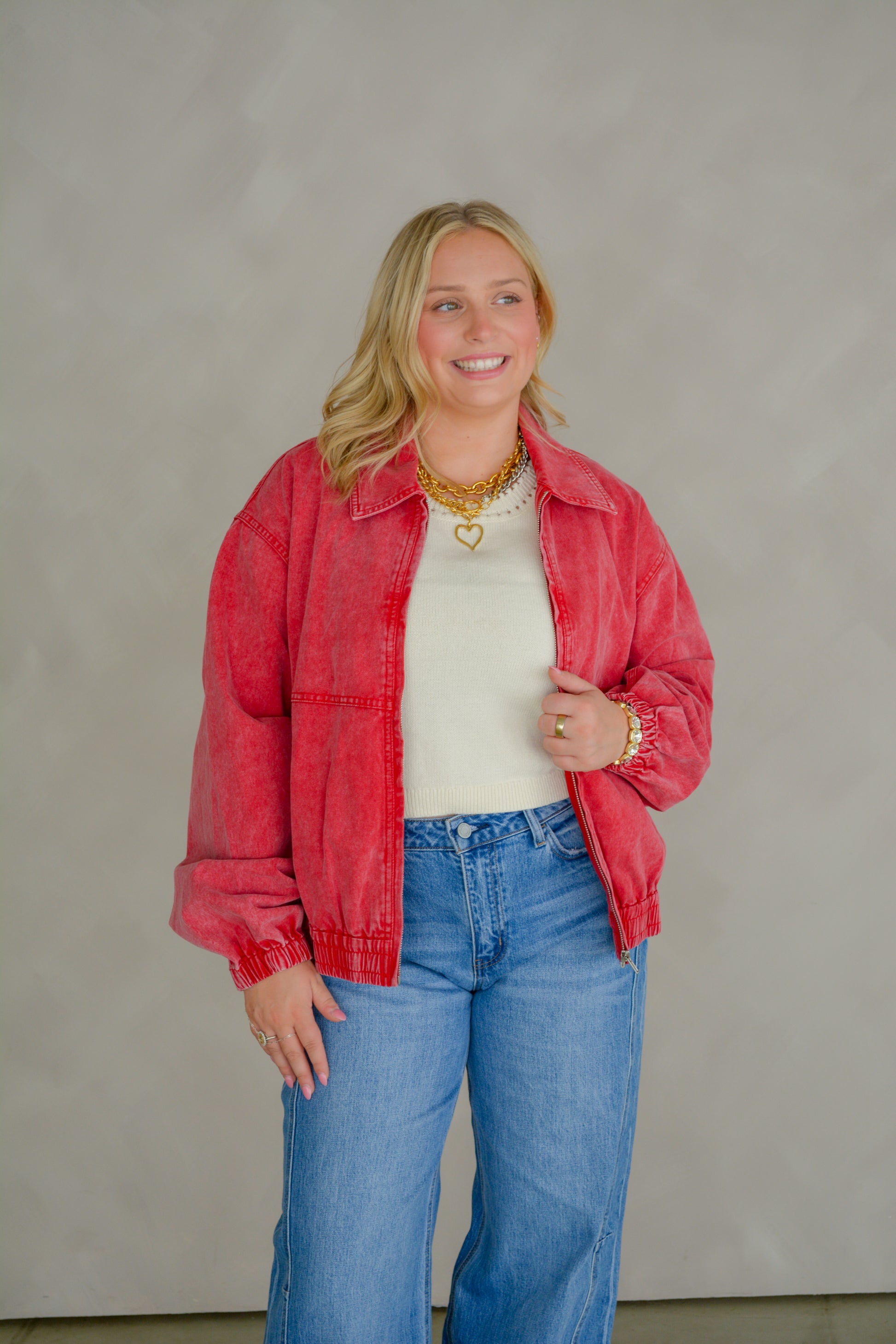 TCEC Dusty Trails denim jacket hanging on a wooden hanger, showcasing classic blue denim with metal button closures.
