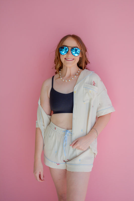 LE LIS The Vacation Edit shorts displayed on a hanger, featuring a casual, relaxed fit in lightweight fabric for summer wear.