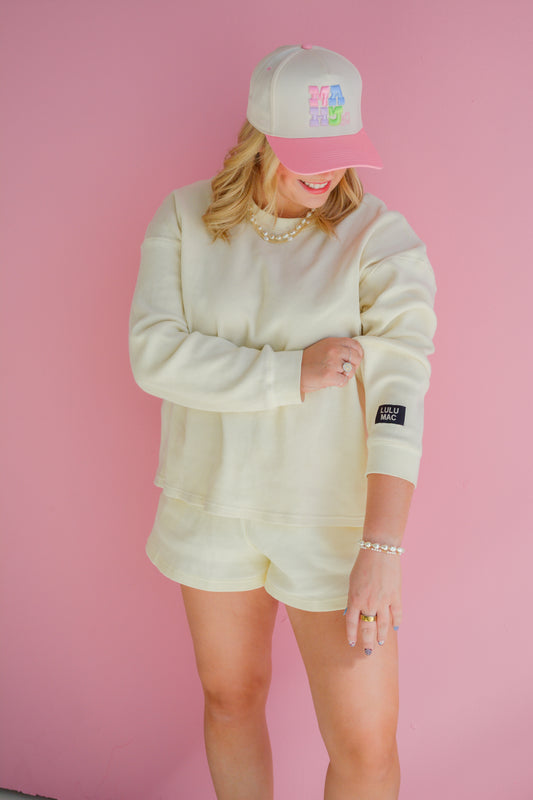 Lulu Mac Buttercup Breeze waffle knit top displayed on a hanger with a soft, textured fabric and relaxed fit.