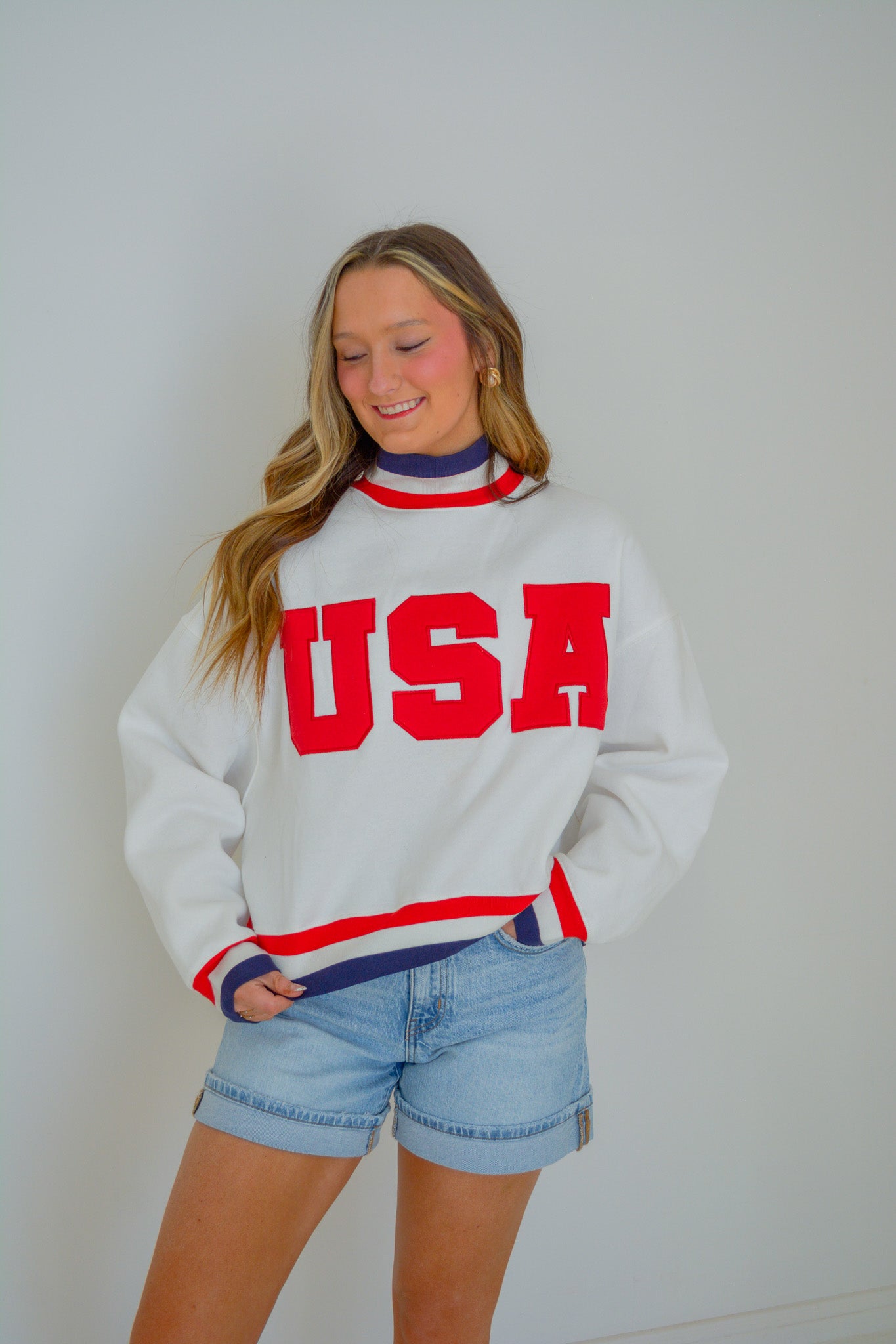 Blue The All-American Pullover by TCEC, showing a front view of the casual sweatshirt with ribbed cuffs and collar.