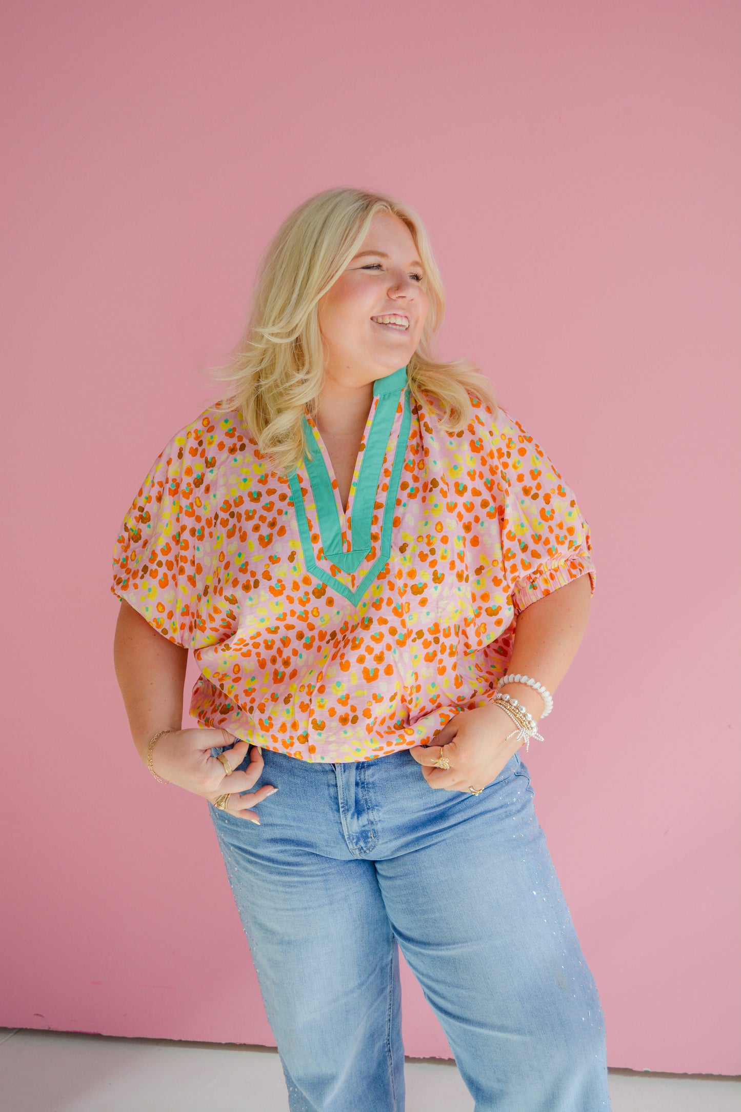 Entro Sunset Sorbet Blouse for Curvy women, featuring vibrant colors and flowy fabric, displayed on a hanger.
