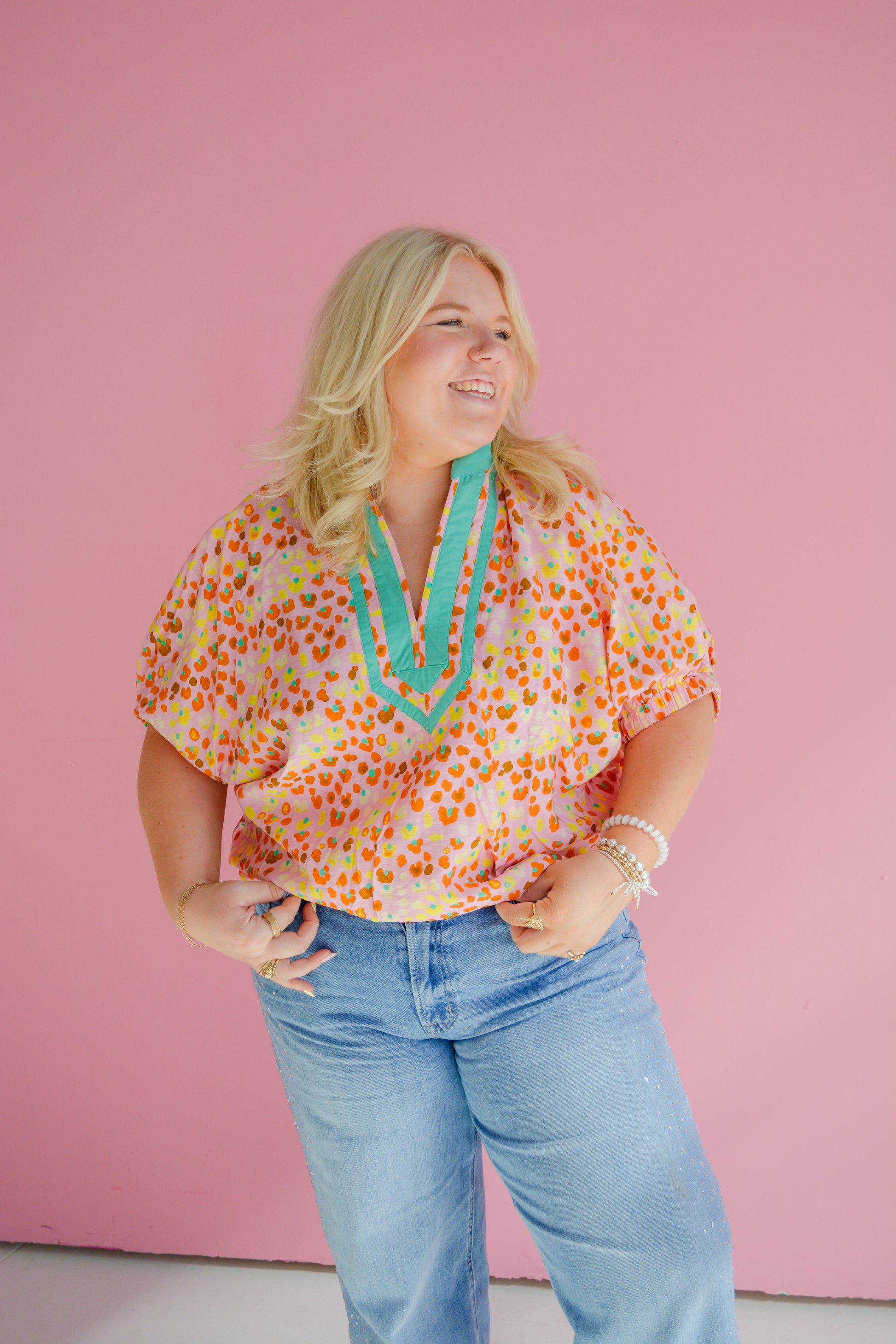 Entro Sunset Sorbet Blouse for Curvy women, featuring vibrant colors and flowy fabric, displayed on a hanger.