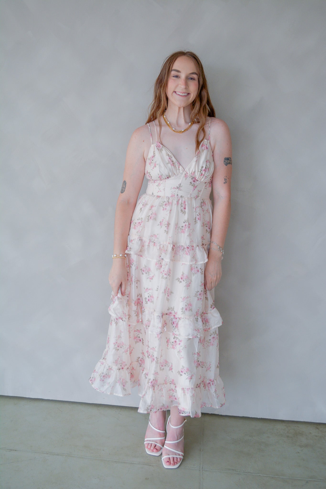Storia Pastel Petals Dress featuring a flowy fabric and floral print, displayed on a hanger against a neutral background.