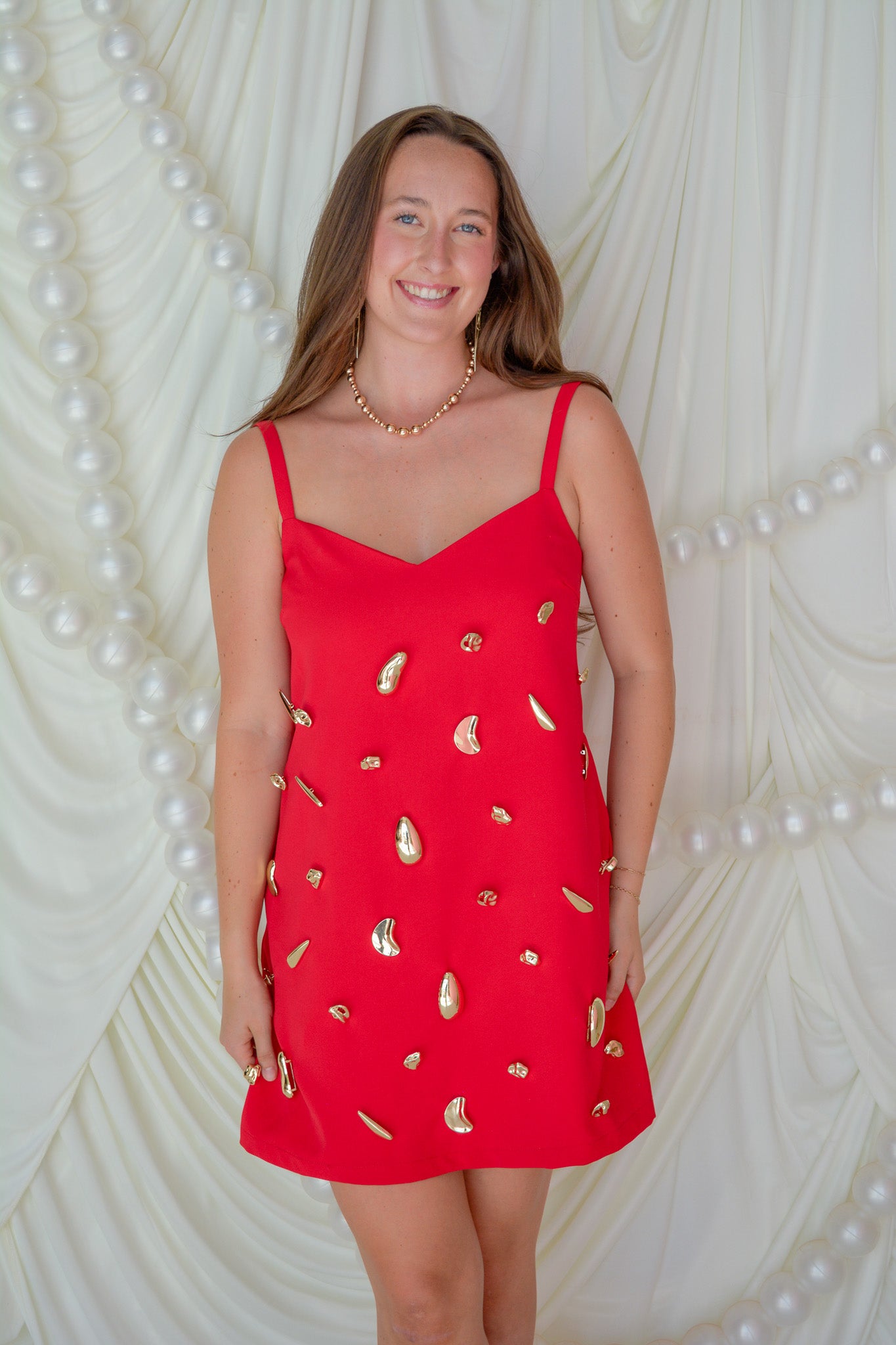 INA Modern Heirloom Dress displayed on a hanger, showcasing its elegant design and detailed fabric.