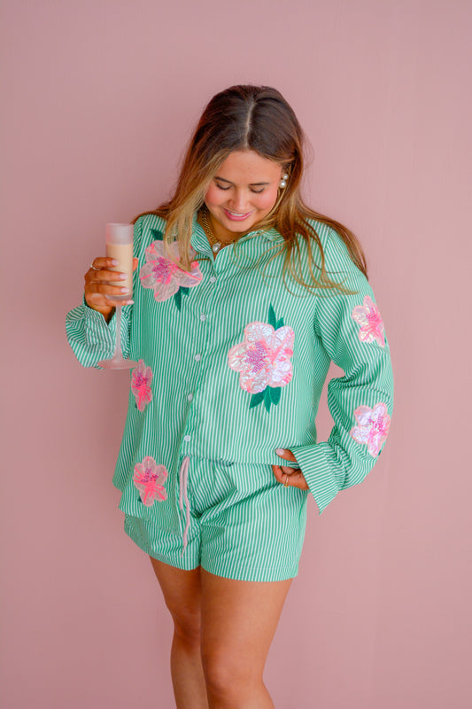 Azalea green stripe shorts by Brianna Cannon displayed on a hanger, featuring a stylish casual design with vertical green and white stripes.