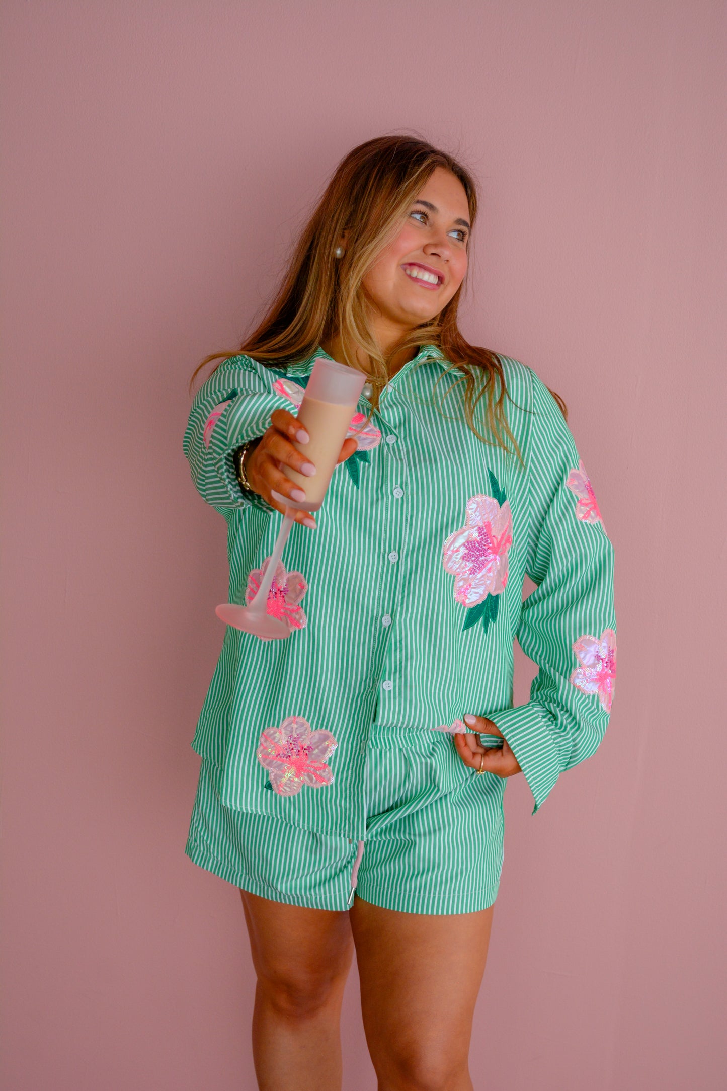 Brianna Cannon azalea button-down shirt hanging on a rack, featuring a classic collar and long sleeves.