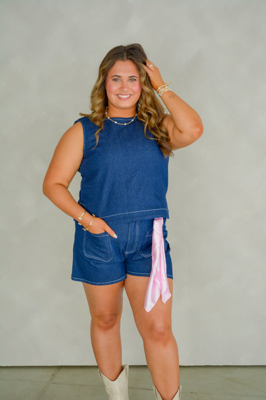 Baby Pink Western Wash Shorts featuring distressed denim, front pockets, and a classic fit, displayed on a hanger.