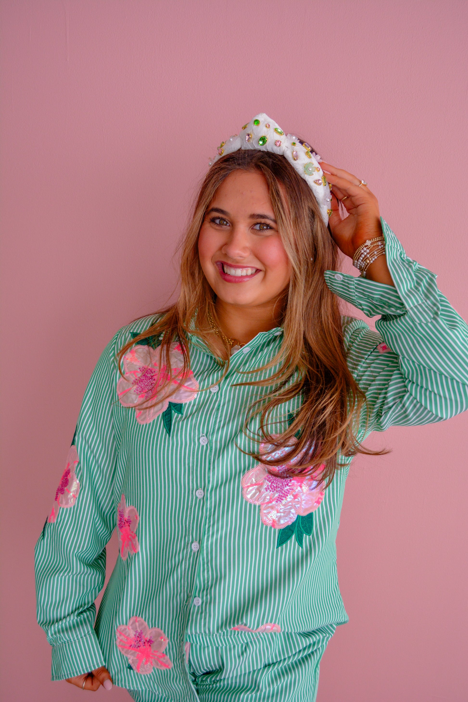 Brianna Cannon azalea button-down shirt displayed on a hanger, showcasing its vibrant color and classic collar style.