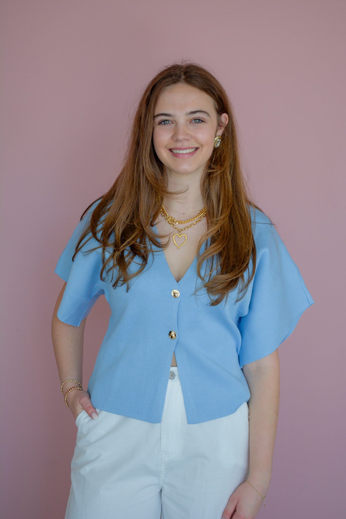 Wisteria Lane Baby Blues Top displayed on a hanger, featuring soft blue fabric with ruffled sleeves and delicate detailing.
