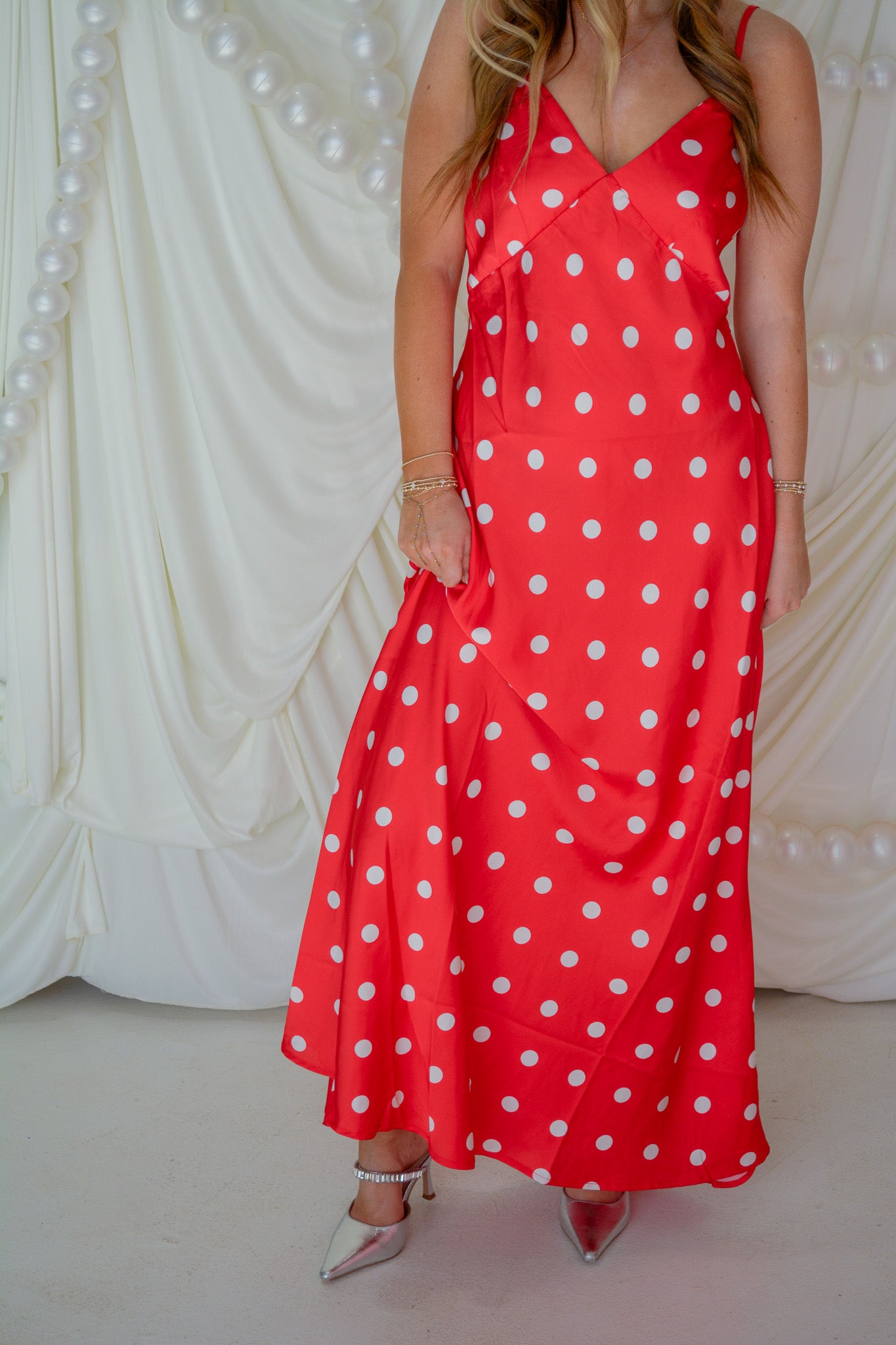 Eesome Dottie Delight Dress displayed on a hanger, showcasing its stylish polka dot pattern and feminine design.