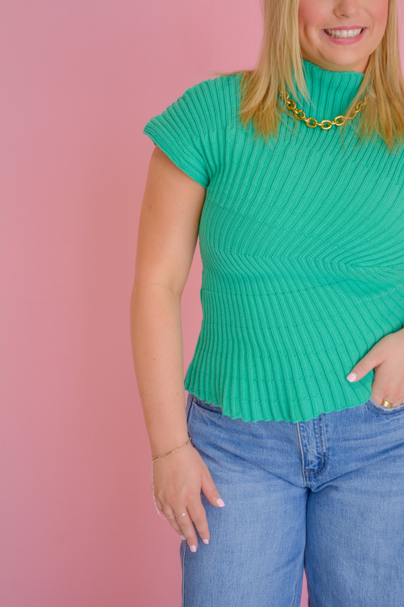 Entro Seaside Sculpt Sweater Top in soft fabric, featuring a relaxed fit and ocean-inspired design, displayed on a hanger.
