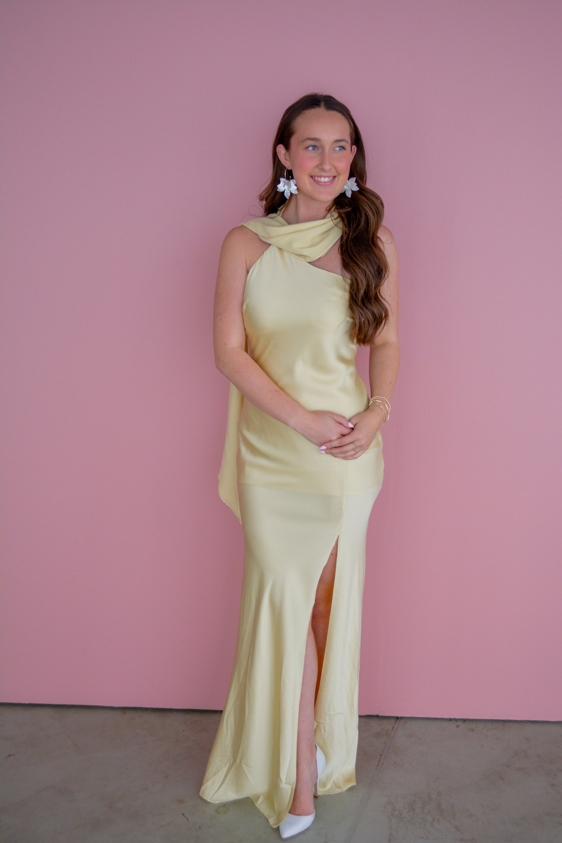 Light pink The Andee Dress by Fore Collection displayed on a hanger, showcasing its soft fabric and elegant design.