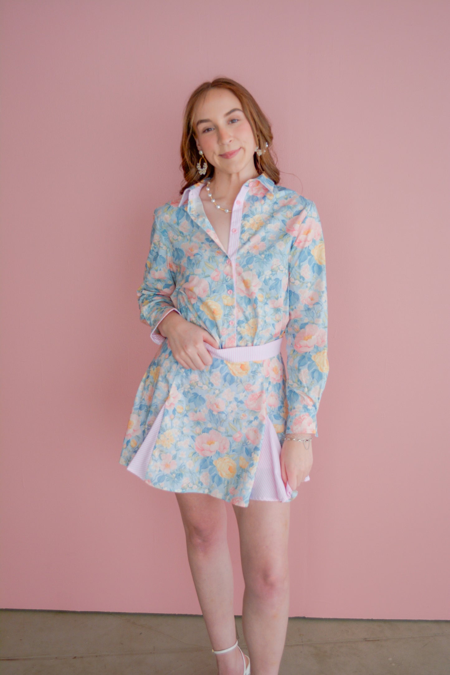 Brianna Cannon preppy floral pleated skirt with a high waist and vibrant flower pattern, displayed on a hanger.