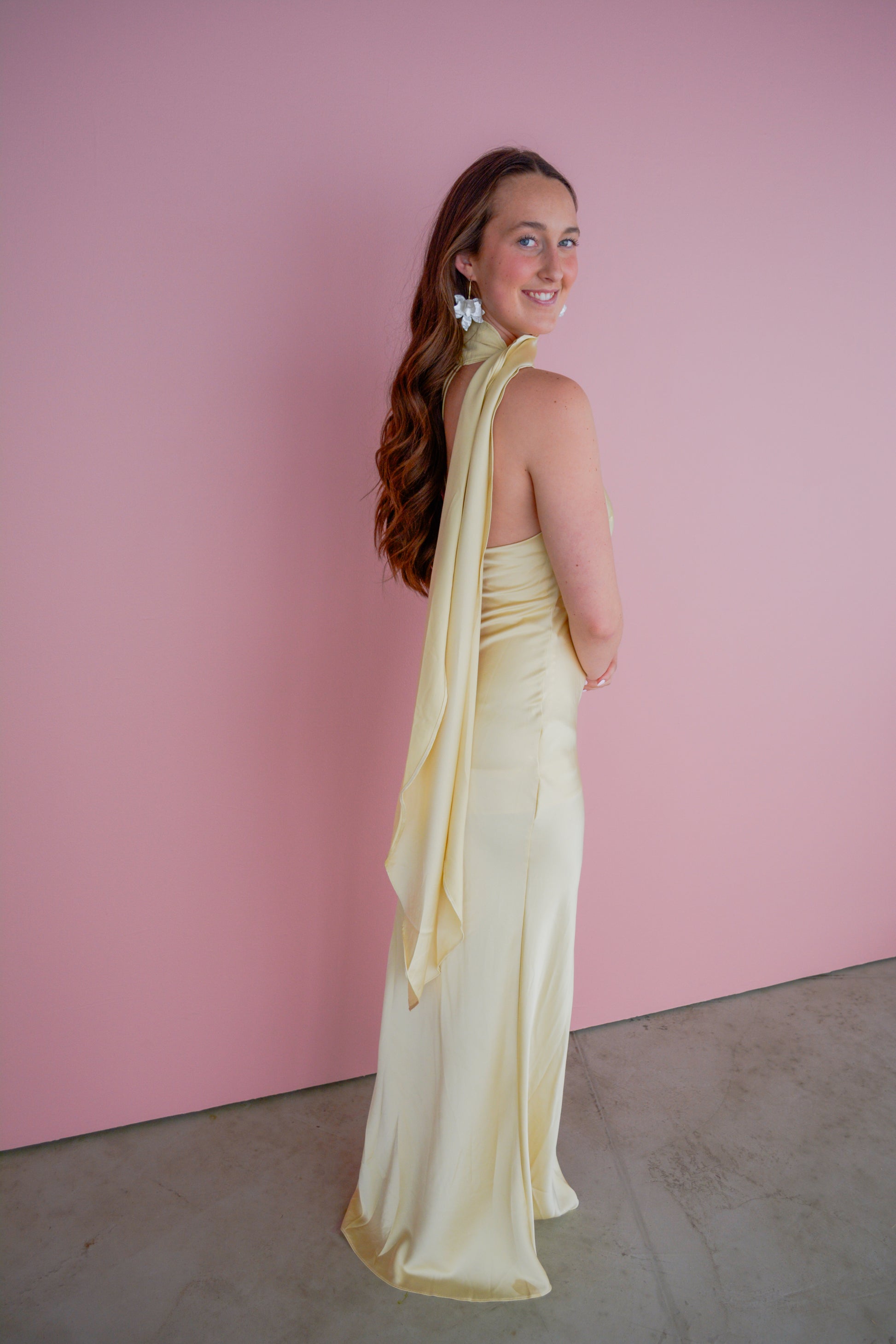 Fore Collection The Andee Dress displayed on a hanger, featuring a stylish, flowy design with vibrant patterns.