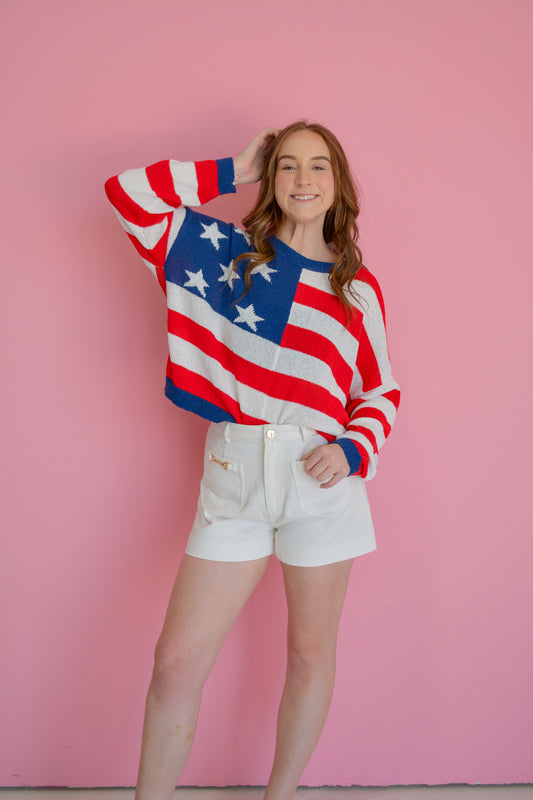 TCEC Stars & Stripes knitted sweater featuring patriotic red, white, and blue star and stripe pattern on soft knit fabric.