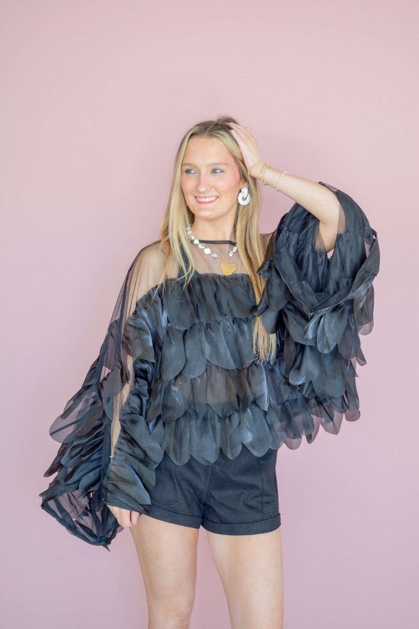 INA Midnight Romance Ruffle Top featuring soft fabric and ruffled details, displayed on a hanger with a neutral background.