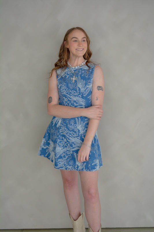 Baby Pink Anneliese embroidered denim mini dress, showing a stylish sleeveless design with detailed embroidery on the front.