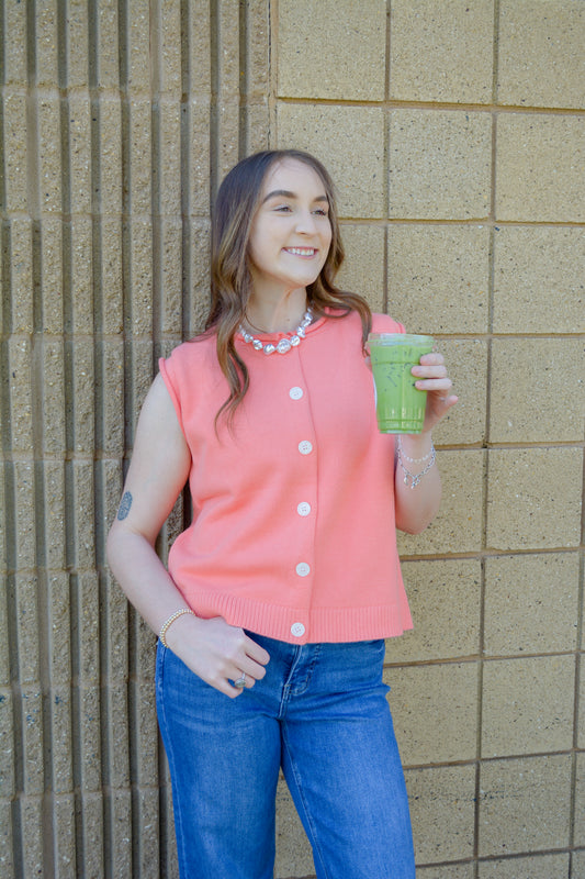 Wishlist Apparel Keegan Sweater Vest Top in melon color, close-up of the sleeveless knit vest with V-neck design.