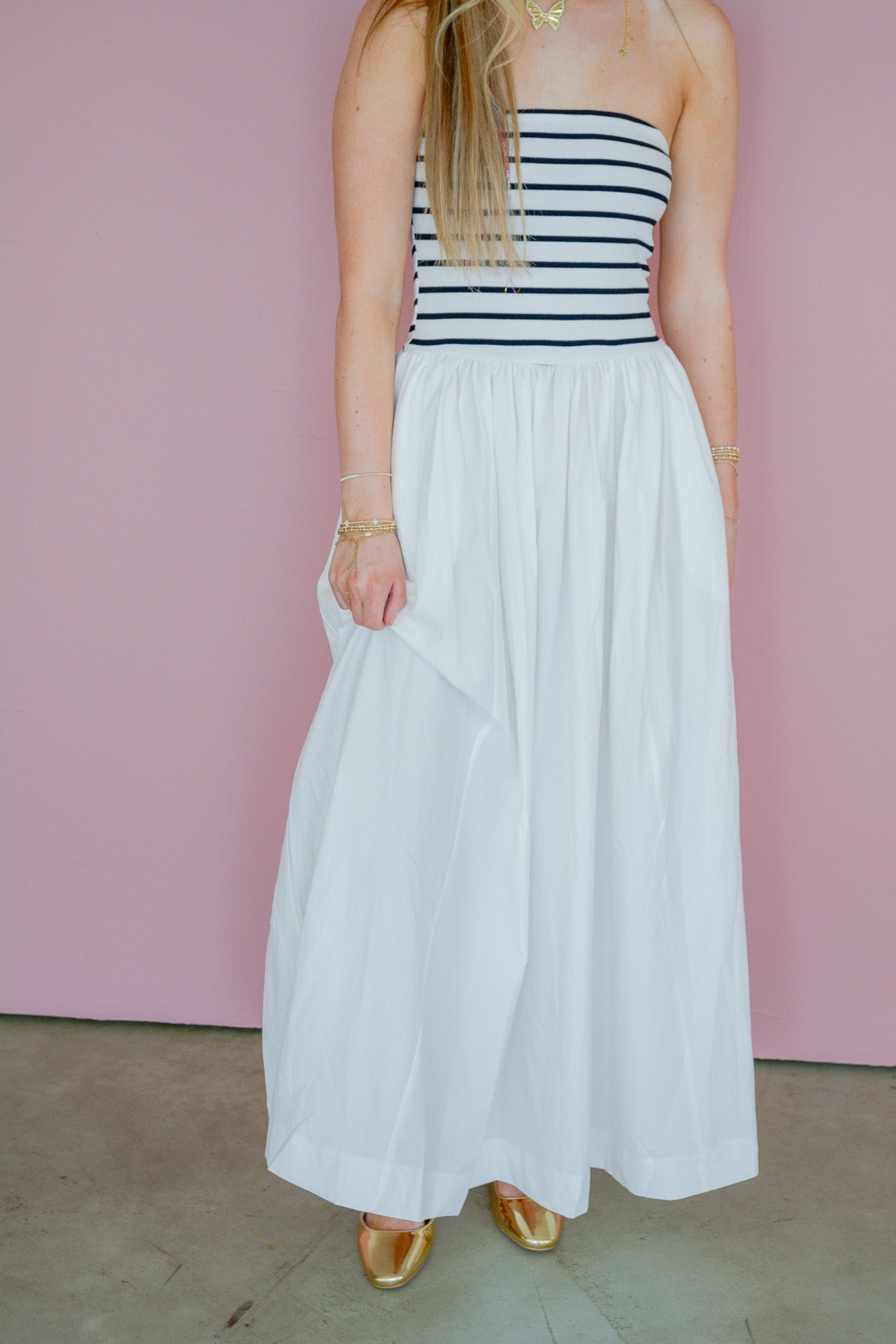 Hyfve Everywhere Midi Dress displayed on a hanger, showcasing its flowy fabric and midi length in a neutral setting.