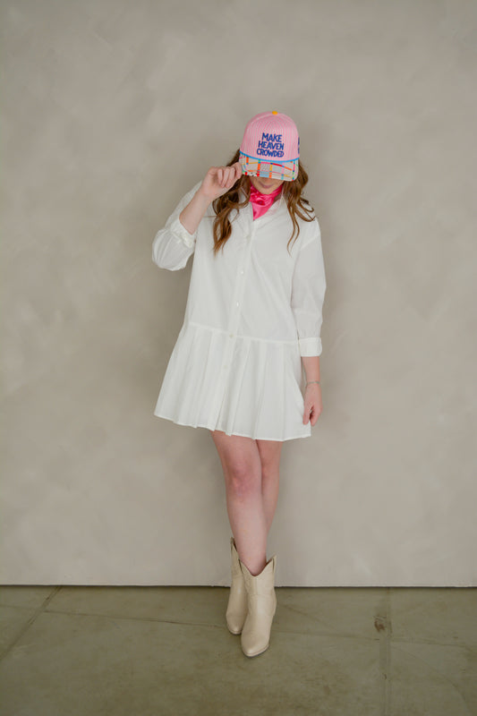Able Poppy Pleated Shirtdress displayed on a hanger, featuring a flowy, pleated design with a button-up front and collar.