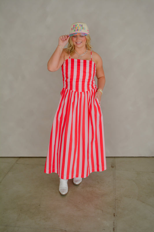 TCEC The Brunch & Go Dress displayed on a hanger, featuring a stylish, casual design in light fabric with floral accents.