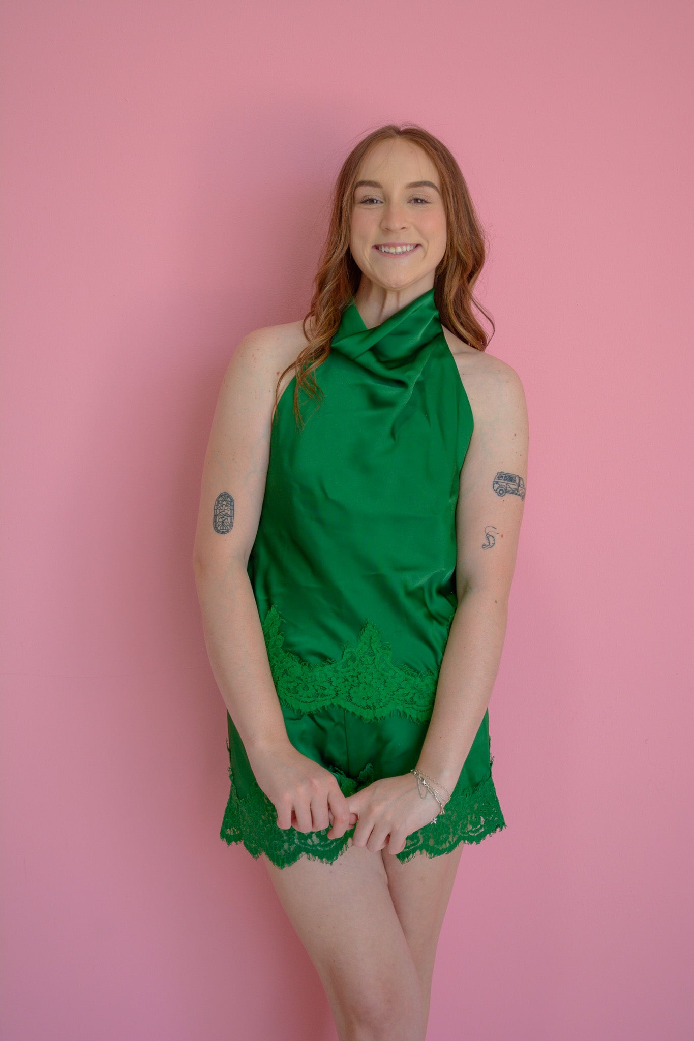 GLAM Silk Haven Emerald Top displayed on a hanger, showcasing its smooth silk fabric and vibrant emerald color.
