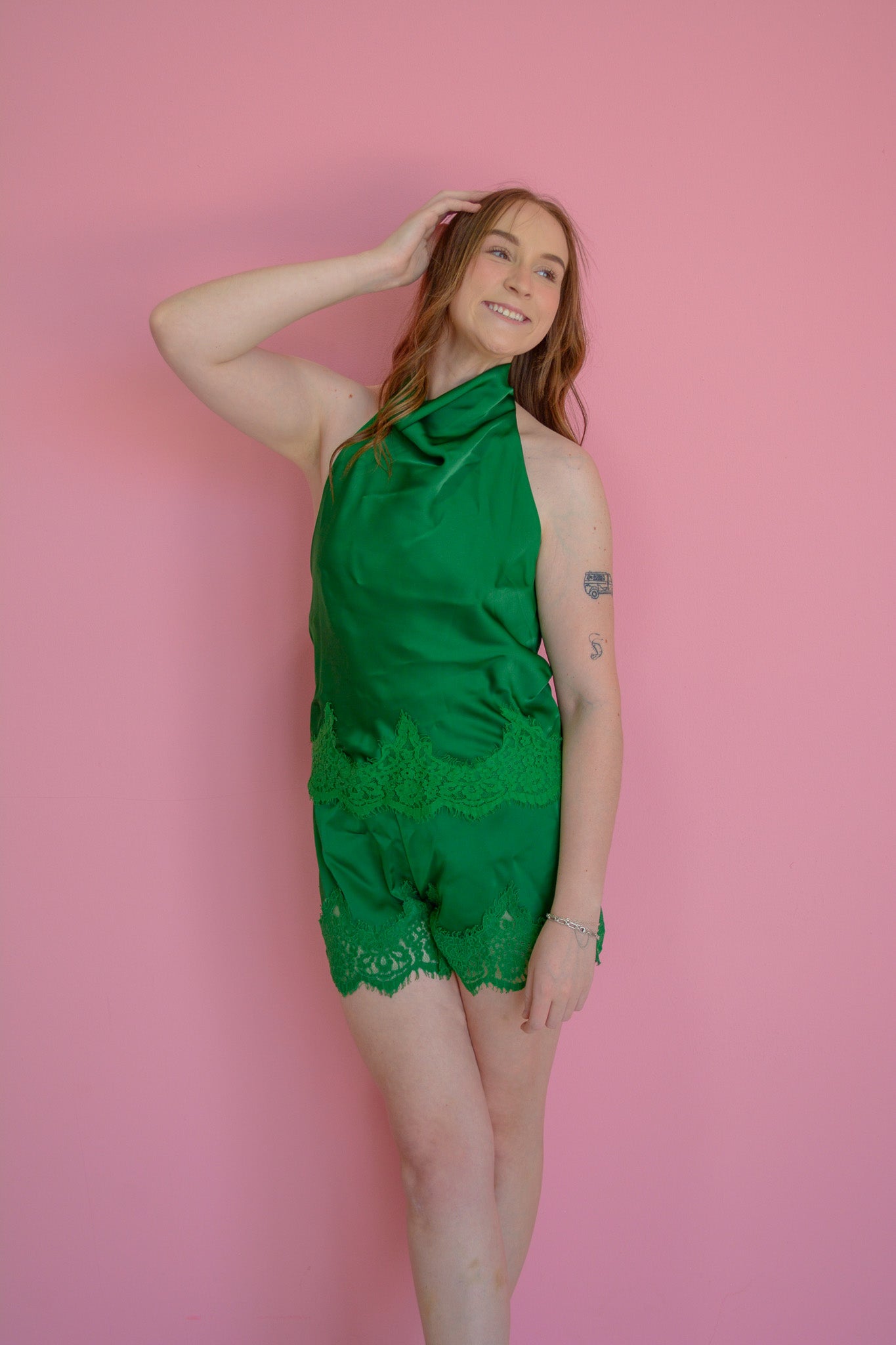 GLAM Silk Haven emerald shorts displayed on a hanger, showcasing smooth silk fabric and stylish design.