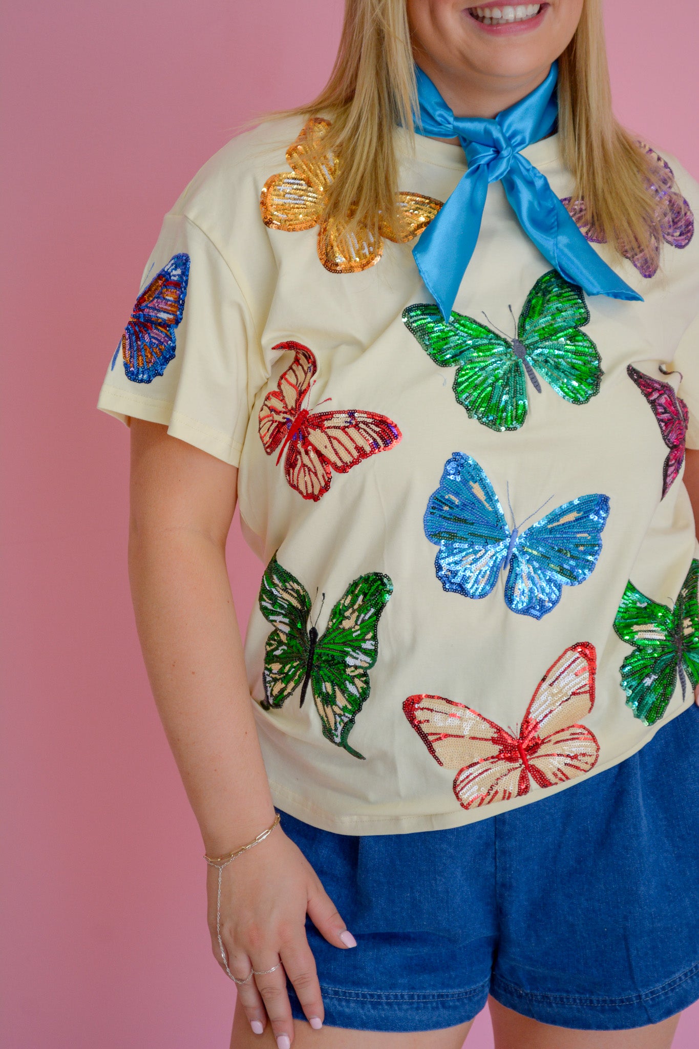 RJM Glitz Butterfly Bliss Sequin Tee featuring colorful butterfly and sequin embellishments on a stylish women's top